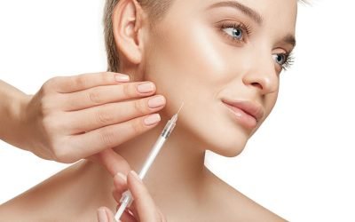 People, Lips, cosmetology, plastic surgery and beauty concept - beautiful young woman face and hand with syringe making injection
